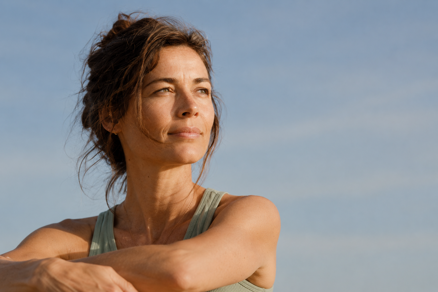 Woman in a clinical setting, looking directly at camera